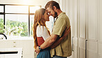 Hug, forehead touch and couple in home for love, bonding and relationship in morning. Dating, happy and man embrace woman together for connection, romance and affection for commitment in kitchen