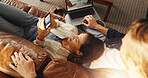 Laptop, phone and couple relaxing on sofa in home with research, social media or network. Computer, cellphone and man with woman in living room for connectivity, contact or communication from above.