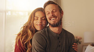 Buy stock photo Smile, couple and embrace in home for love, care and support with partner. Happy man, woman and connection in living room for healthy relationship, loyalty and commitment for marriage together