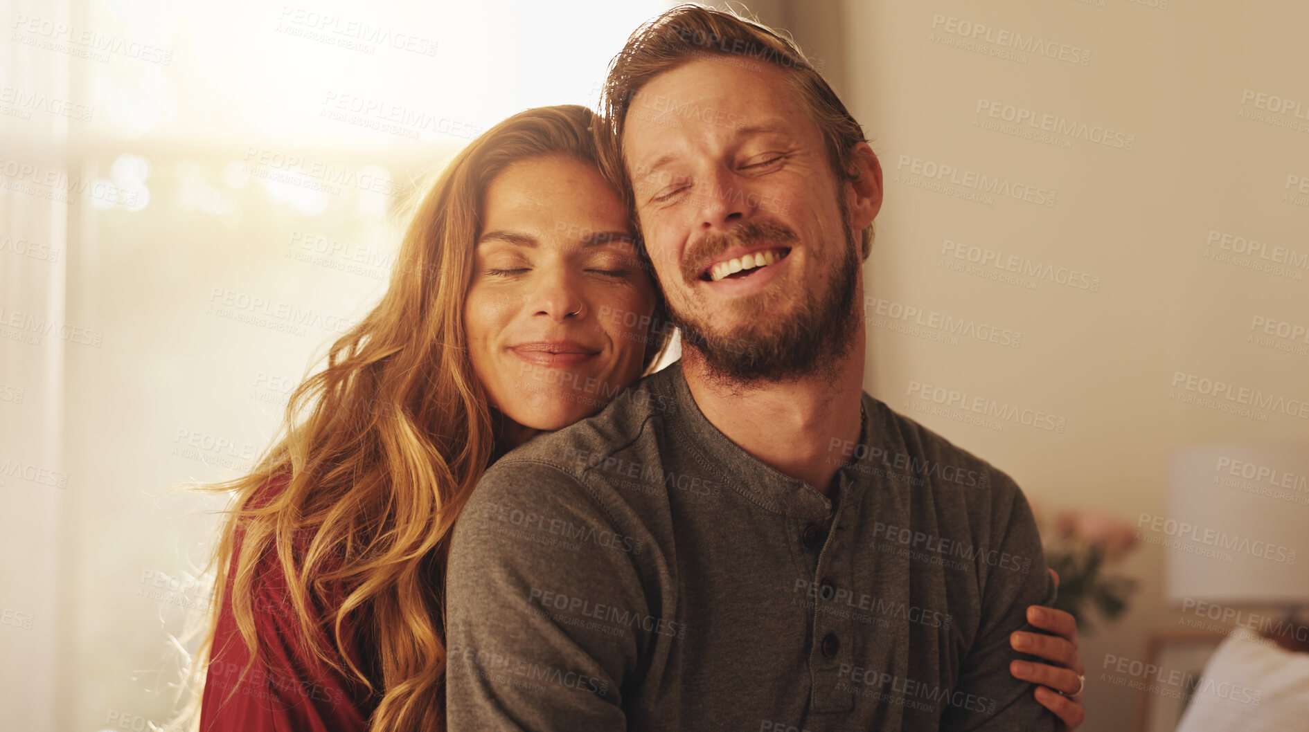 Buy stock photo Smile, couple and embrace in home for love, care and support with partner. Happy man, woman and connection in living room for healthy relationship, loyalty and commitment for marriage together