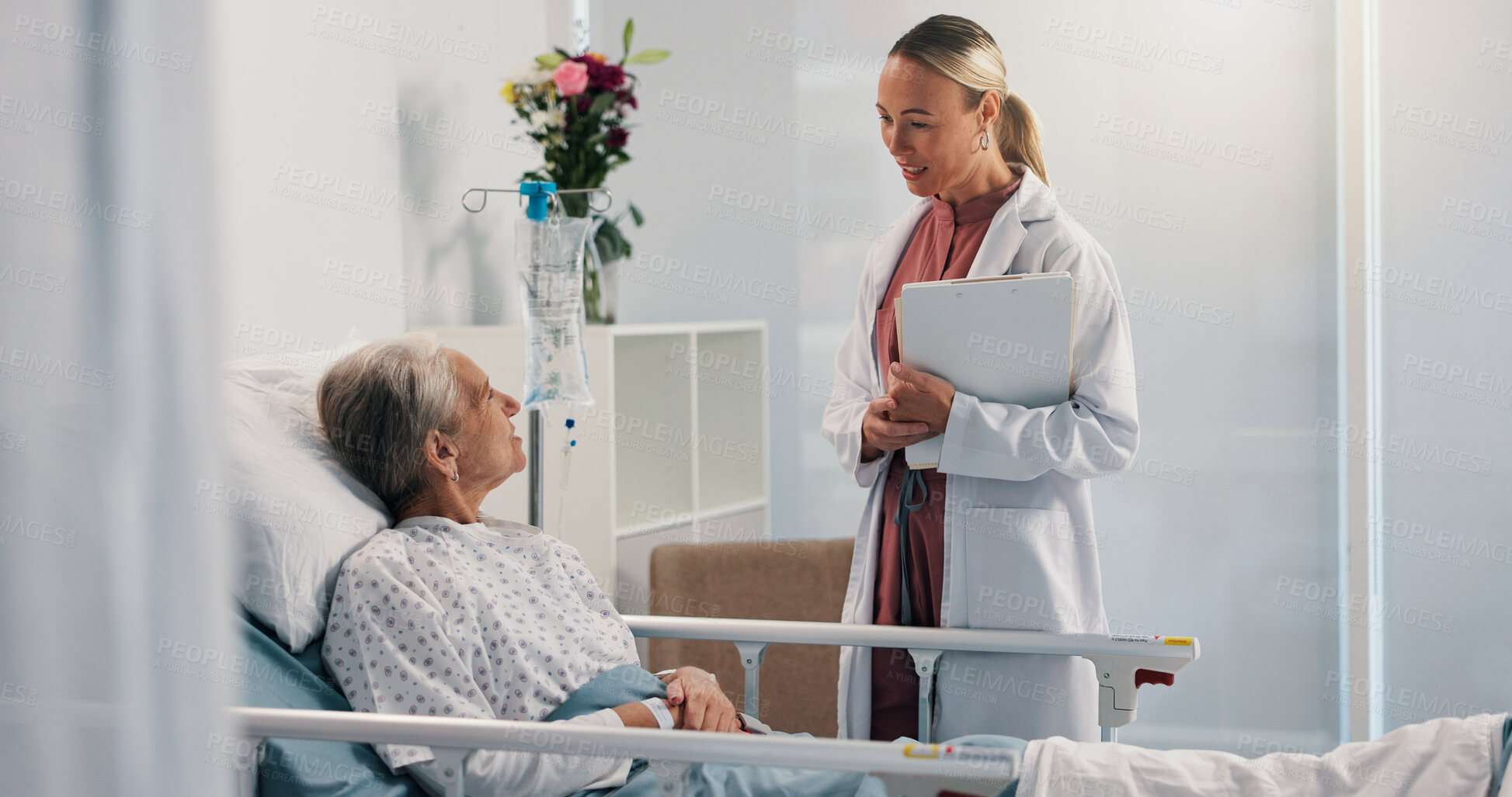 Buy stock photo Elderly patient, doctor and clipboard by hospital bed for report, talk and recovery in retirement. Senior woman, medical consulting and illness for advice, checklist and info with smile at clinic