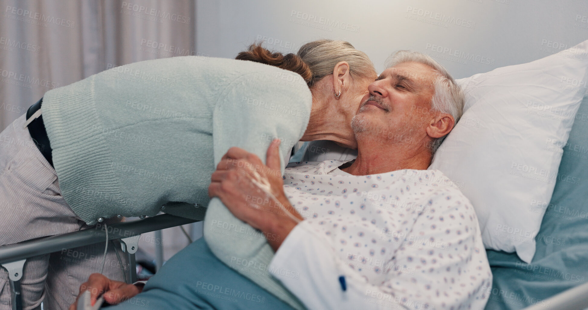 Buy stock photo Senior couple, hug and kiss in hospital bed for care, love or support for healing in retirement. Elderly people, man and woman with kindness for trust, loyalty and patient in rehabilitation at clinic