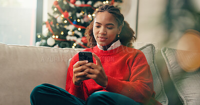 Buy stock photo Christmas, ecommerce and phone with black woman in living room of home for online shopping. App, browsing and retail checkout with African person in apartment to purchase gift or present on internet
