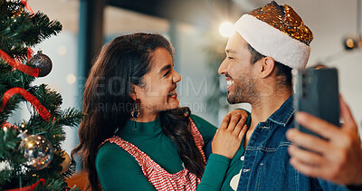 Buy stock photo Happy couple, christmas and home with tree for selfie, picture or December memory together. Man, woman or lovers with smile, photography or capture moment for festive holiday or new year celebration