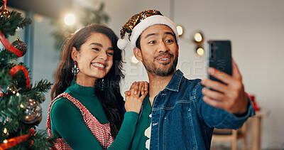 Buy stock photo Christmas, selfie and social media with couple in home living room for celebration together. December, holidays or smile of man and woman in apartment for memory, photograph or profile picture