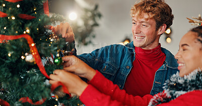 Buy stock photo Christmas, home and couple with tree, tradition and bonding together with love, decorating or smile. Interracial, relationship or man with woman, Xmas and marriage with celebration and festive season