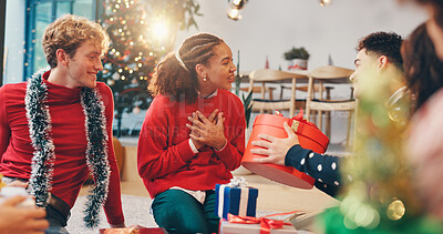 Buy stock photo Christmas, surprise and love with friends and gift for holiday season, festive party and celebration. Present, thank you and reunion with group of people in home for xmas tradition, bonding and care