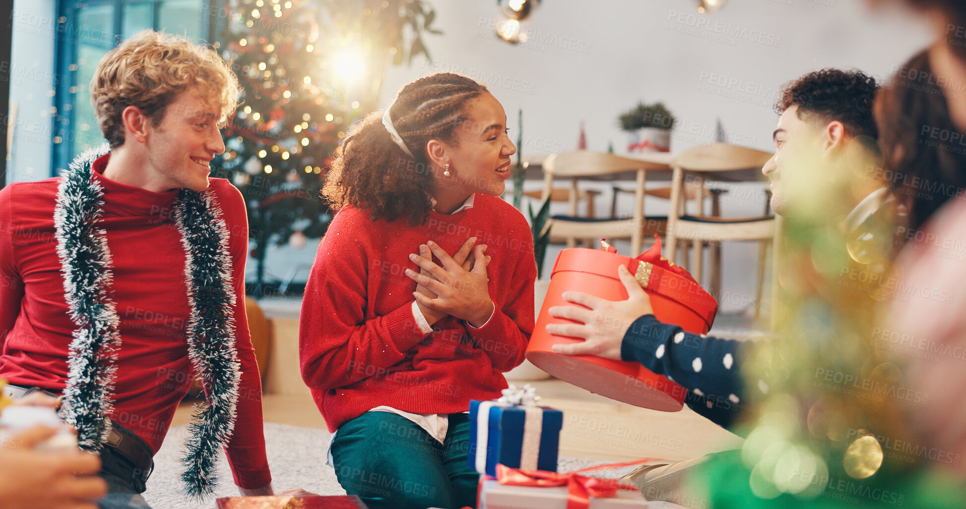 Buy stock photo Christmas, surprise and love with friends and gift for holiday season, festive party and celebration. Present, thank you and reunion with group of people in home for xmas tradition, bonding and care
