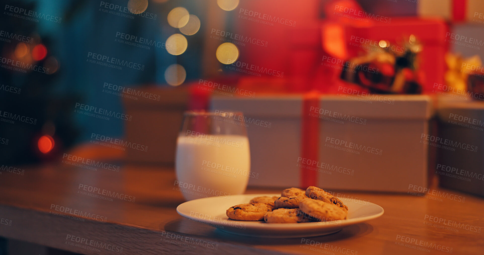 Buy stock photo Christmas, cookies and milk on table in living room of home for celebration or December tradition. Biscuit, drink and presents with sweet food in apartment for culture, superstition or welcome