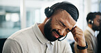 Burnout, headache and stress with man in call center for help or solution as virtual assistant. Anxiety, headset and pain with agent in coworking office for customer service or online support