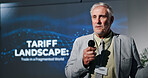 Microphone, seminar and speech with business man in auditorium for presentation in tariff landscape. Development, symposium and workshop with mature speaker on podium or stage for tax conference