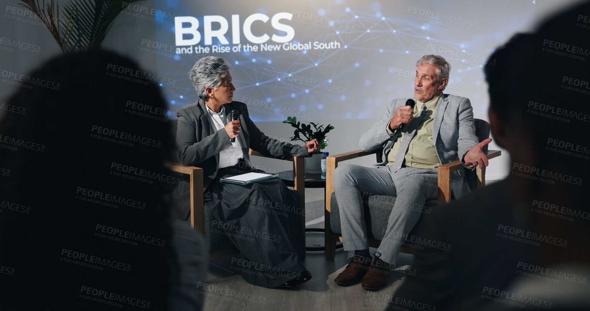 Buy stock photo Interview, presentation or speech with business people on stage for BRICS conference or discussion. Development, microphone and question with mature speakers in auditorium for international trade