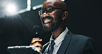 Microphone, speech and tablet with business black man at symposium for announcement or development. App, event and stage with happy African speaker in auditorium for coaching or training conference