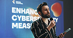 Businessman, presentation or seminar with tablet or mic for speech or cybersecurity convention. Man, employee or speaker with technology display for online safety measures or tradeshow at tech summit