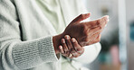 Elderly person, hands or wrist pain with injury for muscle tension or arthritis at hospital checkup. Closeup, senior and patient with sore arm, joint inflammation or carpal tunnel syndrome at clinic