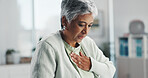 Senior, sick woman and chest pain with heartburn at hospital for clinic checkup, visit or exam. Mature, female person or infection with virus or symptoms for discomfort, acid reflux or gastro disease