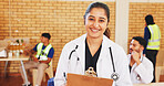 Doctor, clipboard and portrait of happy woman in community center for notes, charity or healthcare. Medical worker, smile and professional at ngo for wellness outreach, humanitarian aid or volunteer