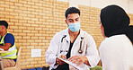 Clipboard, doctor and face mask with man in community center for healthcare checkup. Documents, insurance or volunteer with medical professional and patient at outreach event for charity or medicare