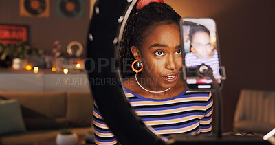 Buy stock photo Black woman, ring light and live streaming with talk in home, chat and late recording in lounge. Girl, video and gen z influencer with mobile app, social media and content creation at night in house