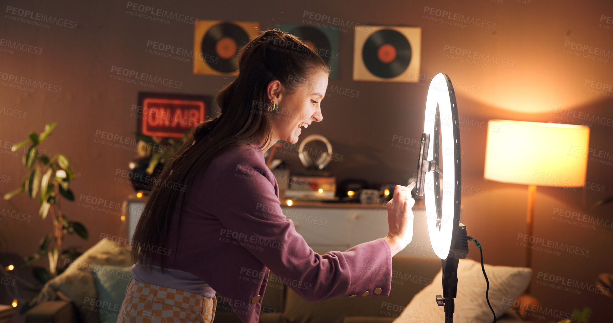 Buy stock photo Influencer, happy and woman in home with ring light for social media, recording video and late upload. Content creator, night and excited with audience for live streaming, subscription and broadcast