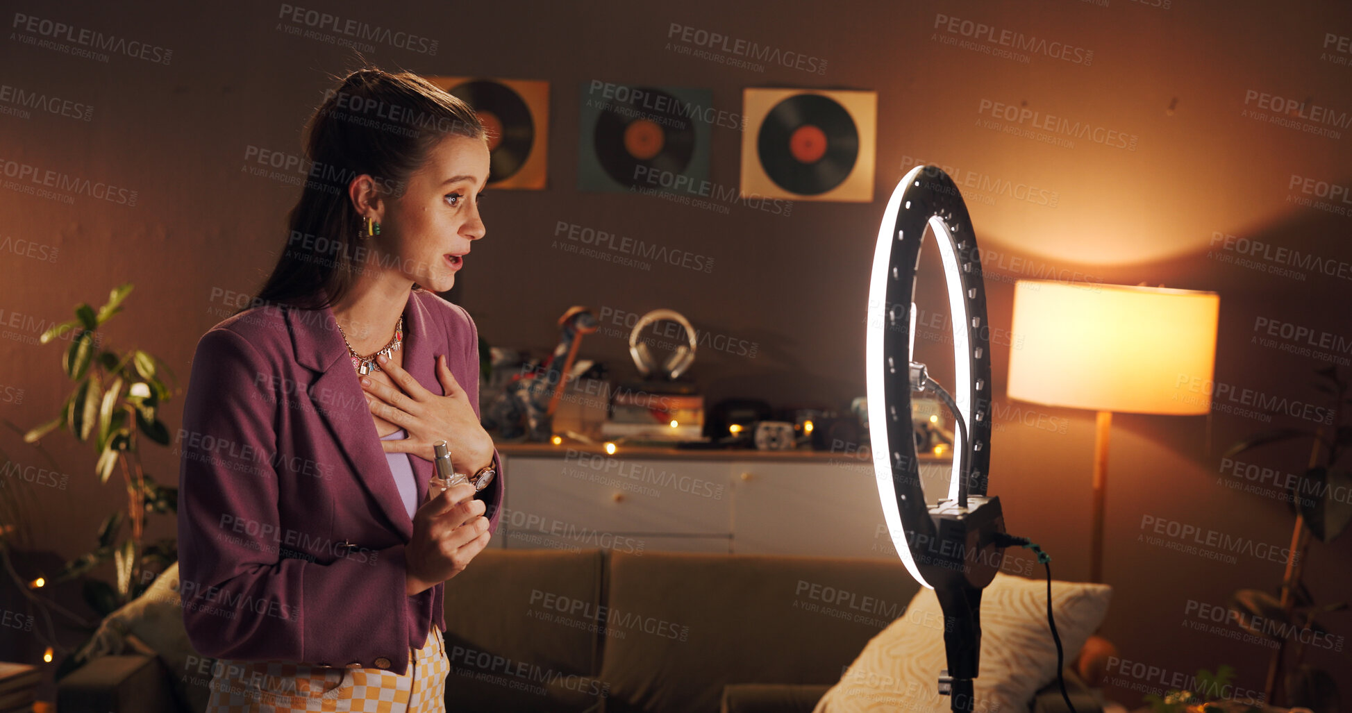 Buy stock photo Influencer, talking and woman in home with ring light for social media, product review and opinion. Content creator, perfume and person with audience for live streaming, brand promotion and recording