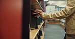 Person, student and hands with bookshelf at library for choice, selection or genre at university. Academic, literature and learner with novel or textbook in study for story, knowledge or education