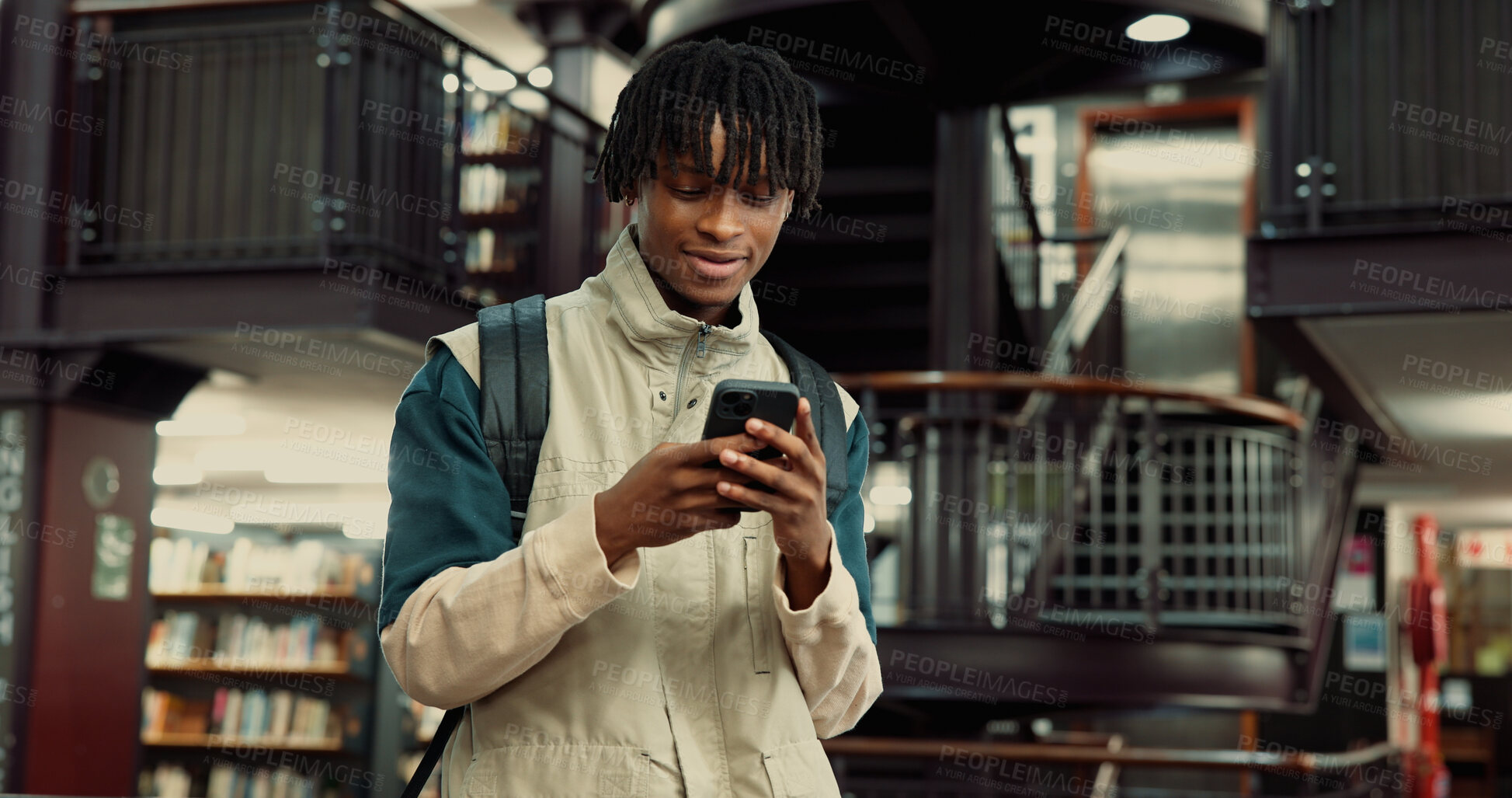 Buy stock photo Phone, happy and black man in university library with contact, networking or email for scholarship. Smile, connectivity and African student with cellphone for communication on mobile app at college.
