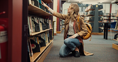 Buy stock photo Student, university and woman in library, search and books with education, research and study. College, shelves and person with scholarship, knowledge and assignment with hobby, decision and learning