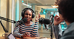 Woman, microphone and guest for talk show in studio for live streaming, broadcast and news. Host, people and hosting interview for online platform, media production and storytelling for radio channel