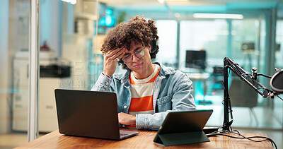 Buy stock photo Headache, studio and man with mic for podcast with burnout, brain fog and fatigue on laptop. Content creator, influencer and person on computer for strain, head pain and tired for live streaming