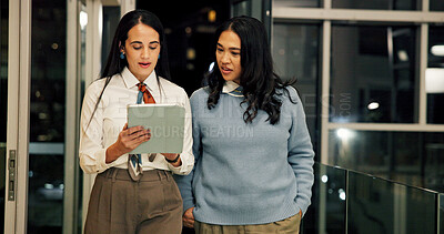 Buy stock photo Business, night and women in office, tablet and collaboration with research for article. Deadline, people and journalists with teamwork, tech and app with analysis for news report or conversation