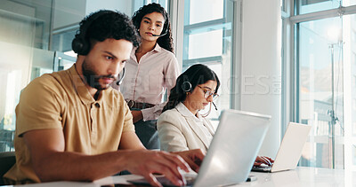 Buy stock photo Online, representative and man with laptop, call center or coworkers with headset for telemarketing. Typing, agent and people with tech for lead generation, telemarketer and sales on web in office