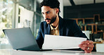 Businessman, accountant and laptop with documents for finance, statistics or review at office. Man, employee or accounting with computer or paperwork for financial planning, company budget or report