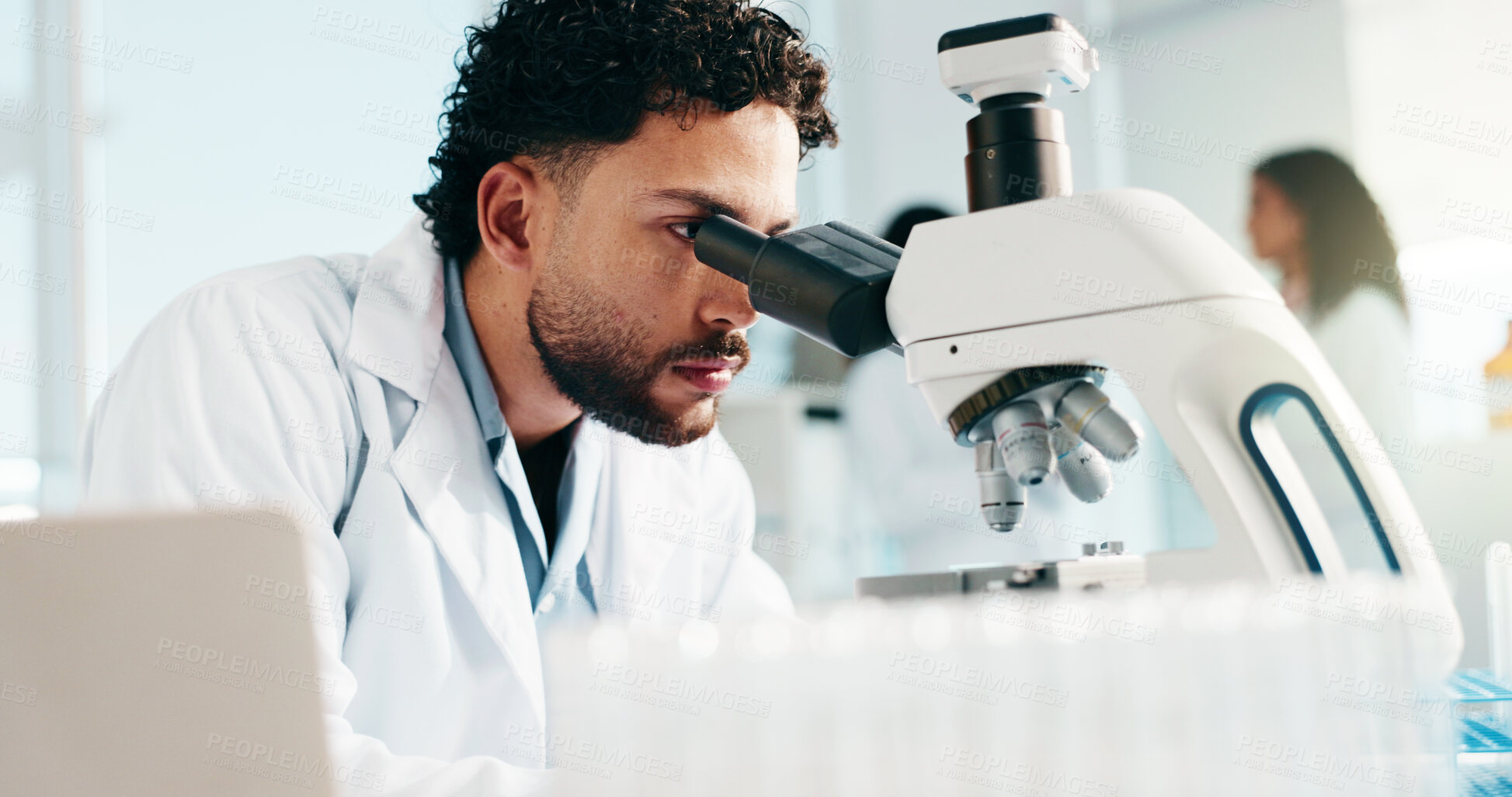 Buy stock photo Man, scientist and microscope for medical study, research or forensic science at laboratory. Male person, healthcare worker or exam with microorganisms for new discovery, analysis or investigation