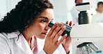 Microscope, woman and scientist in laboratory for analysis, study or research for medical breakthrough. Science, biotechnology and female biologist with pharmaceutical investigation for innovation.