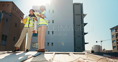 Buy stock photo Women, architecture team and discussion with tablet on construction site, inspection or maintenance. Radio, communication and tech for city planning in low angle, civil engineering and collaboration 