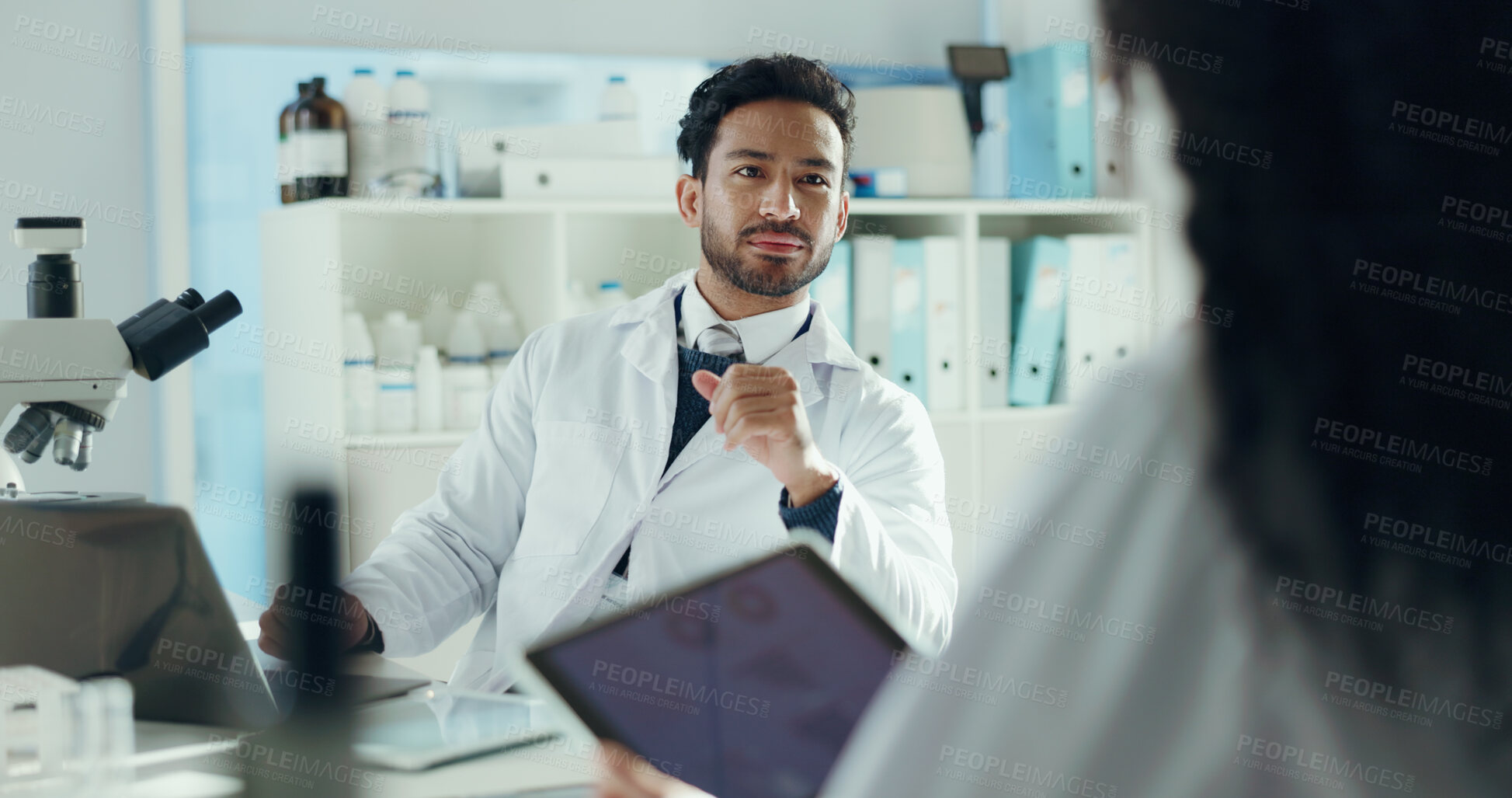 Buy stock photo Man, scientist and discussion in lab with colleague for microbiology study, report or feedback. Team, meeting and technology for medical research, pharmaceutical development and science collaboration