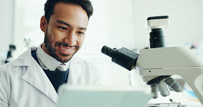 Buy stock photo Science, tablet and happy man with microscope in lab for medical research, study and online results. Healthcare, biology and scientist on digital tech for vaccine report, innovation and experiment