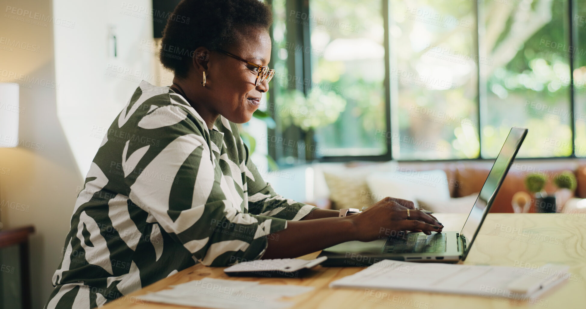 Buy stock photo Typing, woman and remote work with laptop, home or review of financial report, happy or bookkeeping. Freelancer, smile and black person with tech for research, read and info for spreadsheets in house