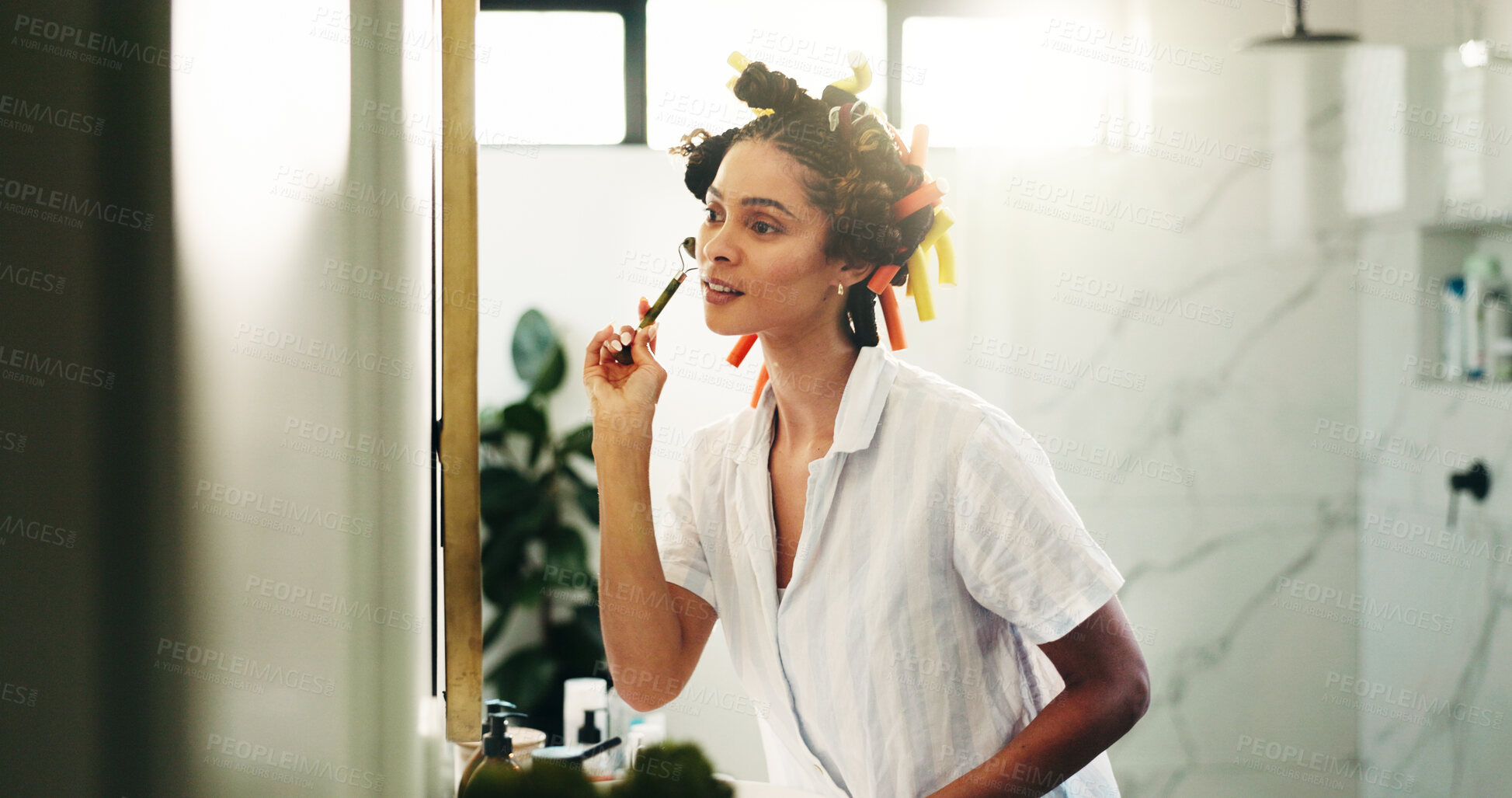 Buy stock photo Bathroom, skincare or woman with jade roller in mirror for grooming, lymphatic drainage or routine. Hair care, person or cosmetics tool in home for skin circulation, beauty treatment or getting ready