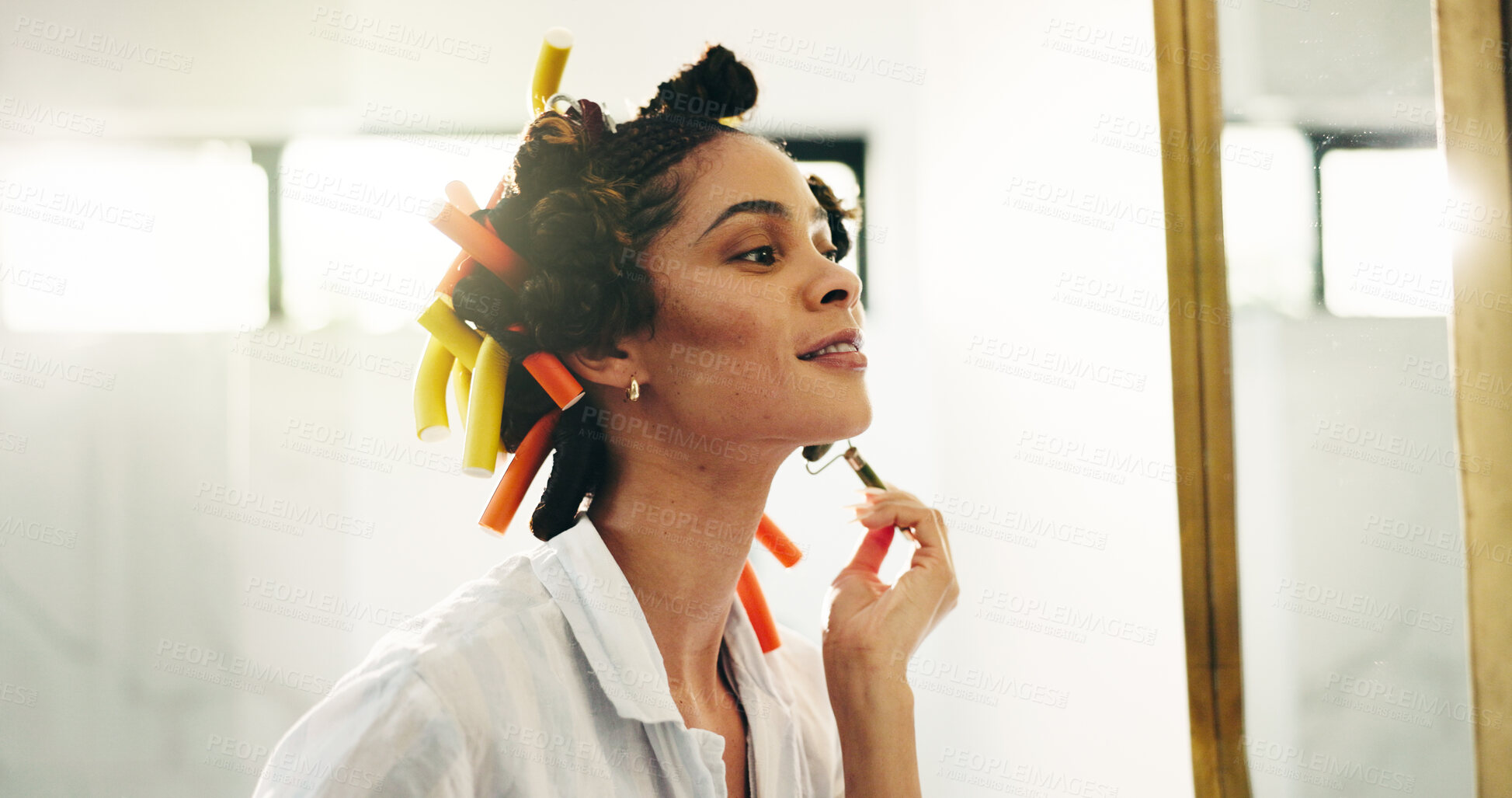 Buy stock photo Happy, woman and routine with jade roller, bathroom or facial treatment for smooth skin or grooming. Smile, getting ready and curlers for haircare in home, glow and person with tool for skincare