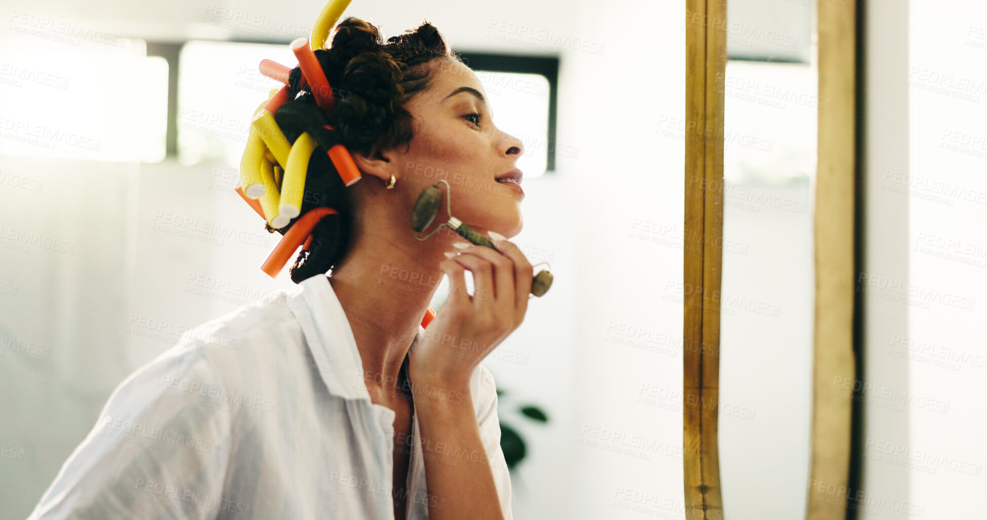 Buy stock photo Bathroom, beauty or woman with jade roller in mirror for natural skincare, getting ready or routine. Haircare, girl or cosmetic tool in home for lymphatic drainage, anti aging or hair curling process