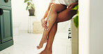 Skincare, legs and woman apply body cream for hydration, wellness and sunscreen for UV protection. Feet, cosmetics and person with lotion for beauty, dermatology and moisturizer in home bathroom