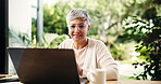 Senior woman, laptop and smile at house of finance report, loan application and review budget. Elderly person, reading and pc of mortgage payment, expenses information and balance account in backyard