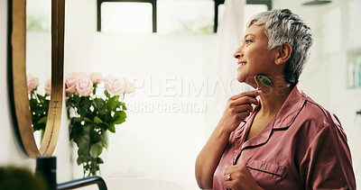 Buy stock photo Senior woman, mirror and jade roller in bathroom to relax with massage product and routine. Mature, reflection or person in home with facial tool for lymphatic drainage, beauty or natural skincare