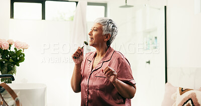 Buy stock photo Jade roller, microphone and senior woman in bathroom for morning, skincare and fun routine. Singing, energy and wellness with mature person in apartment for antiaging, dermatology or karaoke