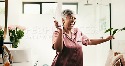 Buy stock photo Dance, energy and excited mature woman in bathroom for morning, skincare and routine. Beauty, jade roller and wellness with happy senior person in apartment for antiaging, dermatology or cosmetics
