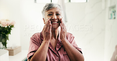 Buy stock photo Senior, portrait or happy woman with lotion for skincare or face cream in bathroom at home. Mature, female person and smile with moisturizer for morning routine, collagen or facial treatment at house