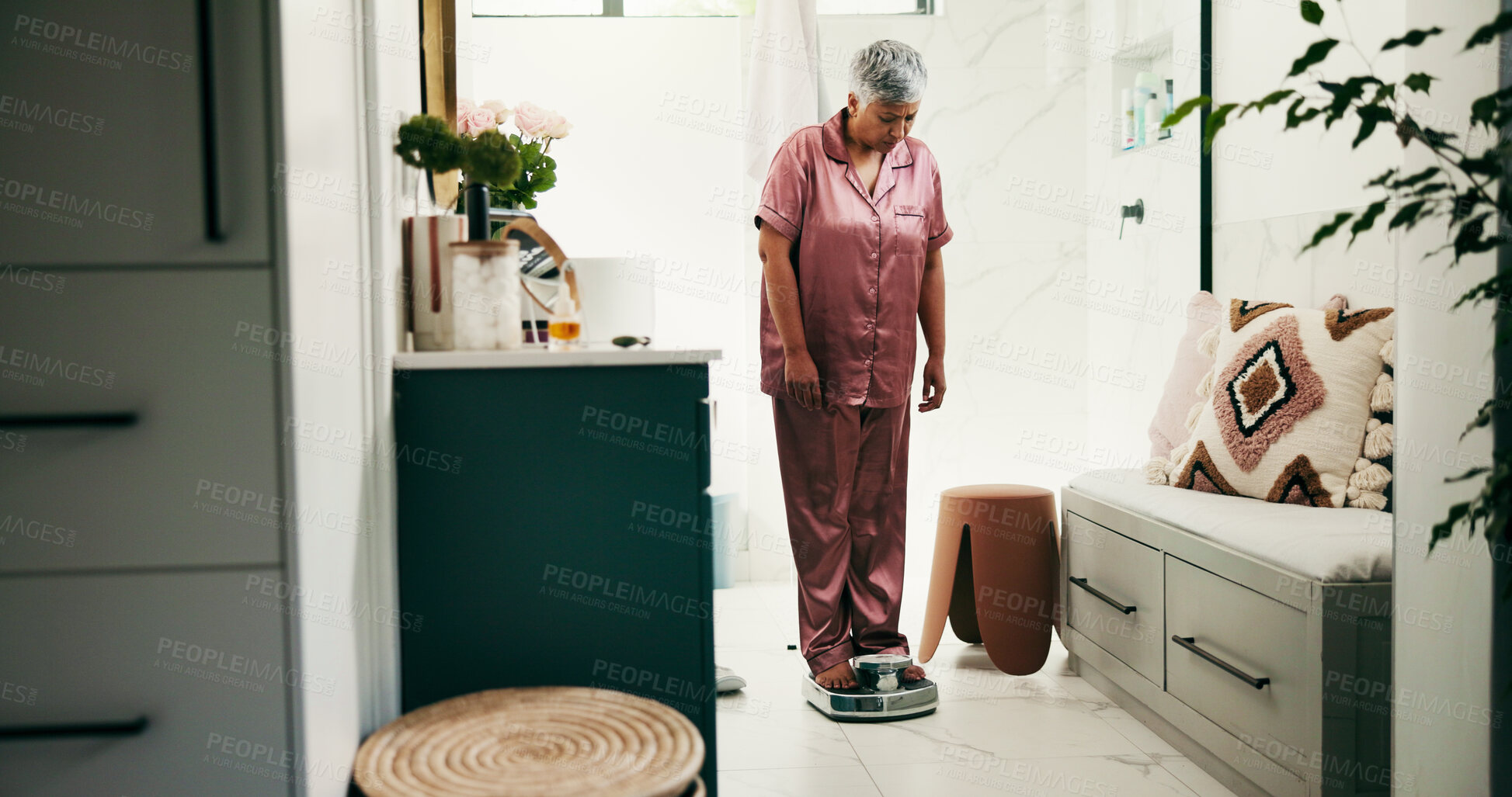 Buy stock photo Senior woman, bathroom and scale for weightloss, diet or checking BMI in pajamas at home. Female person, health and measurement with monitoring tool for body mass, gain or weight results at house