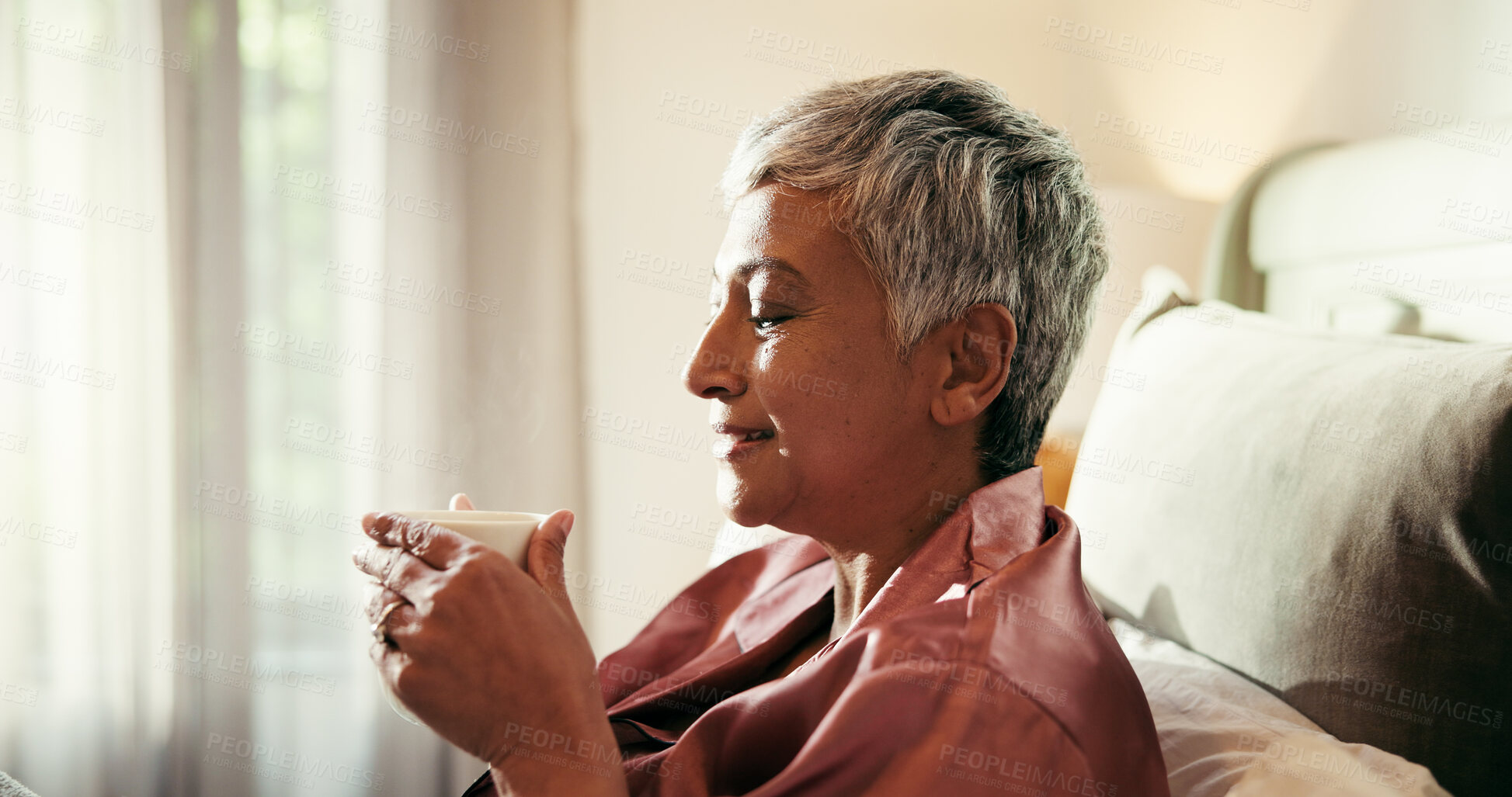 Buy stock photo Coffee, thinking and mature woman with smile in home for memories, nostalgia and morning routine. Relax, bed and wellness with happy, senior person and caffeine beverage in apartment for weekend